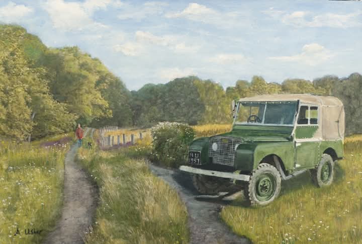 Image of Land rover in a field with man walking